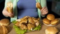 Curvy female preparing to eat chicken and bread, overeating problem, depression Royalty Free Stock Photo