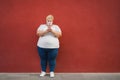 Curvy happy woman using mobile phone while wearing face protective mask for coronavirus disease - Focus on face Royalty Free Stock Photo