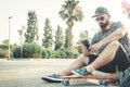 Curvy man with a skateboard answering a message Royalty Free Stock Photo