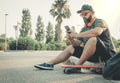 Curvy man with skateboard looking Royalty Free Stock Photo