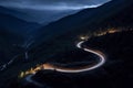 Curvy mountain road with trailing lights at night Royalty Free Stock Photo