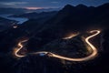 Curvy mountain road with trailing lights at night Royalty Free Stock Photo