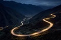 Curvy mountain road with trailing lights at night Royalty Free Stock Photo