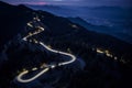 Curvy mountain road with trailing lights at night Royalty Free Stock Photo