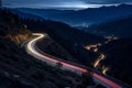 Curvy mountain road with trailing lights at night Royalty Free Stock Photo