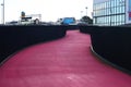 Curvy city Lightpath. Urban walkway in pink color for bicycle riders. Nelson Street Cycleway, Auckland, New Zealand Royalty Free Stock Photo