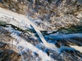 Curvy Road Brodge over Frozen River. Winter Landscape in Mountains. Bieszczady Poland. Drone Top Down View