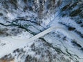 Curvy Road Brodge over Frozen River. Winter Landscape in Mountains. Bieszczady Poland. Drone Top Down View