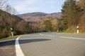 Curvy road between mountains with forest in autumn Royalty Free Stock Photo