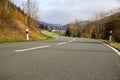 Curvy road between mountains with forest in autumn Royalty Free Stock Photo