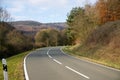 Curvy road between mountains with forest in autumn Royalty Free Stock Photo