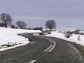 Curvy road on snow covered land Royalty Free Stock Photo