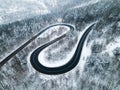 Curvy Windy Road in Snow Covered Forest, Top Down Aerial Drone View Royalty Free Stock Photo