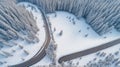 Curvy windy road in snow covered forest, top down aerial view. Royalty Free Stock Photo