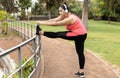 Curvy woman doing sport workout routine outdoor in city park - Focus on face