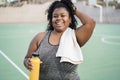 Curvy woman doing workout morning routine outdoor at city park - Plus size and sport exercises concept - Focus on face