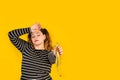 Curvy woman holding a tailor measuring tape and with stressed gesture