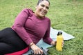 Curvy woman taking selfie with smartphone while doing workout routine outdoor at city park - Plus size and healthy sport lifestyle