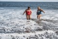 Curvy women playing on the beach having fun on summer time - Focus faces