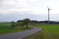 curvycountry road with wind power plant