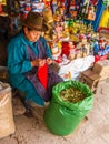 Cusco, Peru - December 13, 2011: Local woman offering Coca leaves