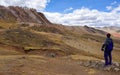 Cusco/Peru - Oct.03.19: boy admires the beautiful view on the Palccoyo rainbow mountains