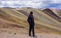 Cusco/Peru - Oct.03.19: boy admires the beautiful view on the Palccoyo rainbow mountains