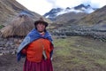 A proud Andean lady stands in front of her farm building in the remote Quesqe Valley. Cusco, Peru