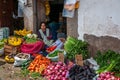 CUSCO, PERU - OCTOBER 8, 2016: Latin American woman sells fresh vegetables and fruits at the market