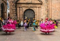 Unidentified participants in traditional clothes celebrate religious festivity in front of the Cathedral of Santo Domingo in Cusco