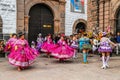 Unidentified participants in traditional clothes celebrate religious festivity in front of the Cathedral of Santo Domingo in Cusco