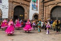 Unidentified participants in traditional clothes celebrate religious festivity in front of the Cathedral of Santo Domingo in Cusco