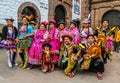 Unidentified participants in traditional clothes celebrate religious festivity in front of the Cathedral of Santo Domingo in Cusco