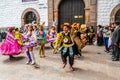 Unidentified participants in traditional clothes celebrate religious festivity in front of the Cathedral of Santo Domingo in Cusco