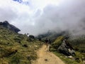 A young group of international hikers, led by their local Inca guide, navigate the Andes mountains through the clouds Royalty Free Stock Photo