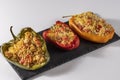 Cuscus, roasted peppers in the oven and stuffed with couscous with vegetables white background