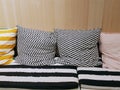 Cushioning Seats with Patterned Pillows Against Wooden Wall on the Back