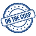 ON THE CUSP text on blue grungy round rubber stamp