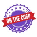 ON THE CUSP text on red violet ribbon stamp Royalty Free Stock Photo