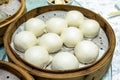 Custard lava cream and roasted red pork filled bun on bamboo tray Royalty Free Stock Photo