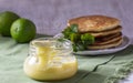 Custard lime curd served with pancakes on a light background. Rustic style.