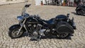 Custom black motorcycle parked in front of the Sanctuary of Our Lady of Nazare in Nazare, Portugal.