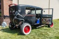 custom black retro-car with the door open, Red wheels and skeletons with skulls on the body and headlights