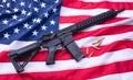 Custom built AR-15 carbine and bullets on American flag surface, background. Studio shot.