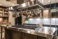 custom-built cooking station featuring glass cooktop, stainless steel hood and hanging pots and pans Royalty Free Stock Photo