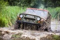 Custom built Off-road Trophy UAZ 469 in the swamp at high speed. Royalty Free Stock Photo