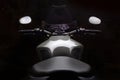 Custom caferacer motorbike on dark background with its headlight on. Royalty Free Stock Photo