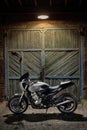 Custom caferacer motorbike on an old garage door background. Royalty Free Stock Photo