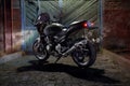 Custom caferacer motorbike on an old garage door background. Royalty Free Stock Photo