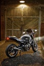 Custom caferacer motorbike on an old garage door background. Royalty Free Stock Photo